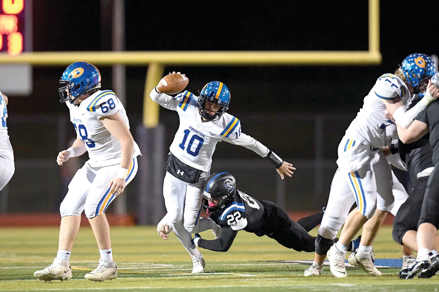 Downingtown West’s Quinn Henicle tries to cut up field while getting tackled by CB South’s Jim Wade.