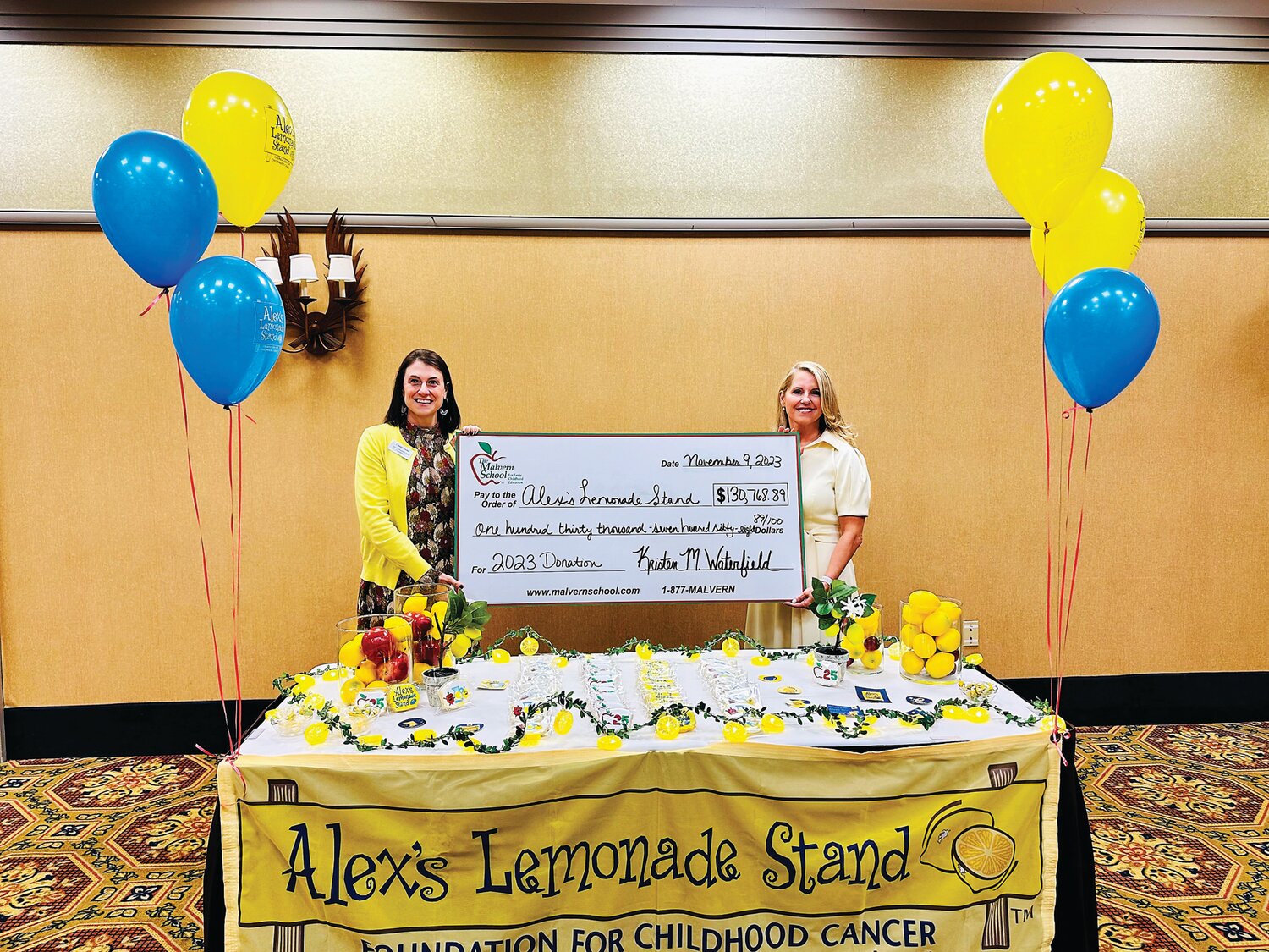Senior Community Engagement Manager Christie Fischer, left, accepts a check on behalf of Alex’s Lemonade Stand Foundation presented by Kristen M. Waterfield, right, founder and president of The Malvern School.