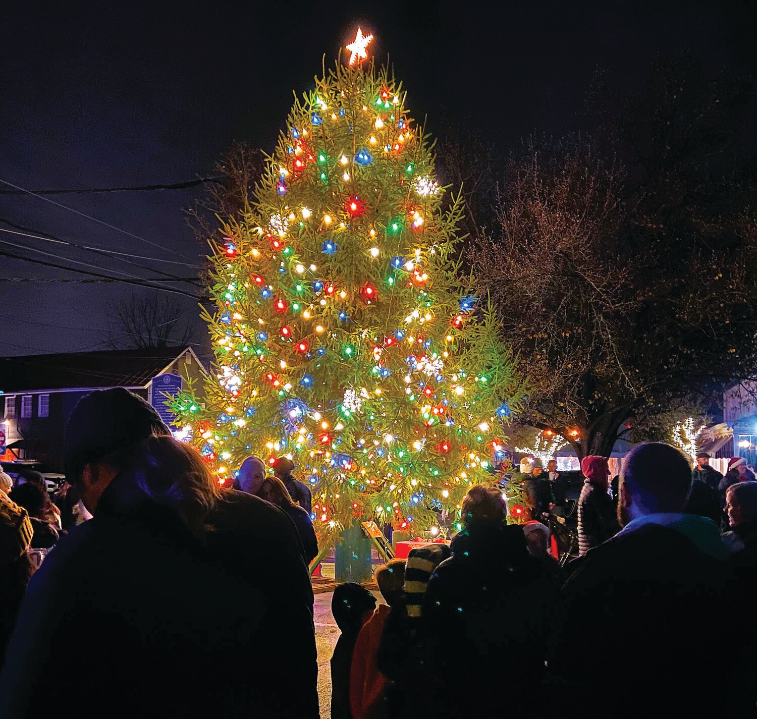 Newtown Borough’s 2023 Christmas tree lighting will take place Friday night. Shown is the 2022 tree surrounded by members of the community.