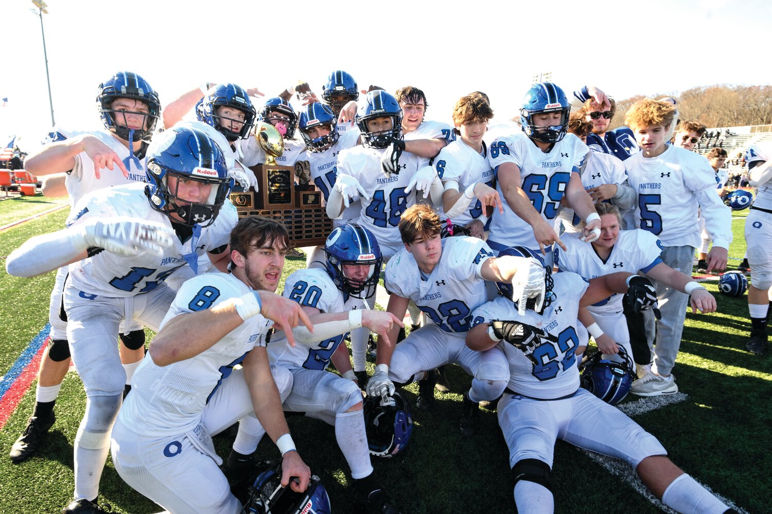 Quakertown players celebrate with the trophy.