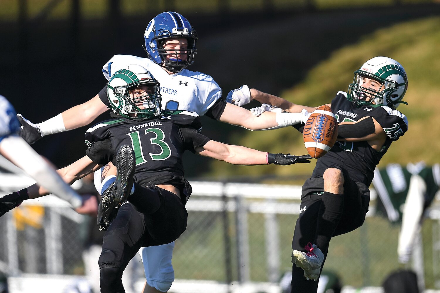 Pennridge’s Chase Marshall and Sam Kuhns break up a pass in the end zone intended for Quakertown’s Anthony Ferrugio.