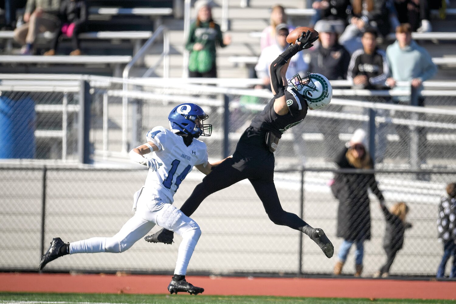 Pennridge receiver Joe Gregorie makes an acrobatic catch during a late fourth quarter drive in front of Quarkertown’s Reagan Payne.