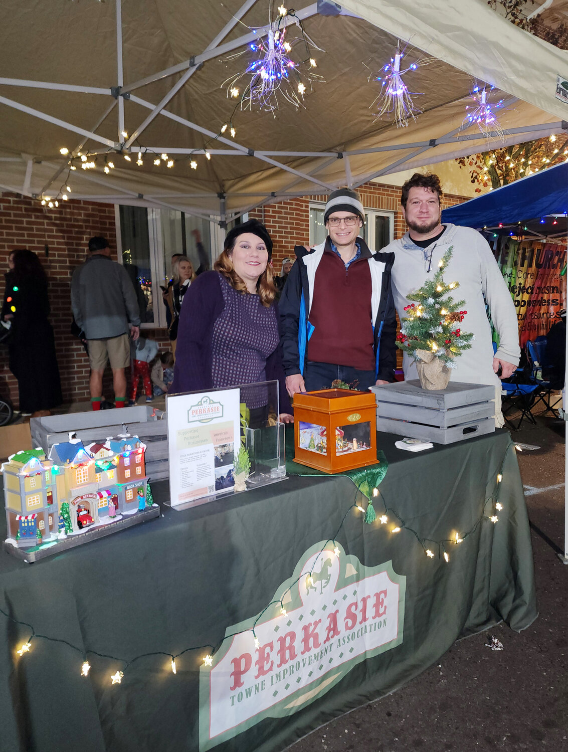(From left) Michelle Cosgrove, Martin Franke and Corey Armideo man the Perkasie Town Improvement Association booth.