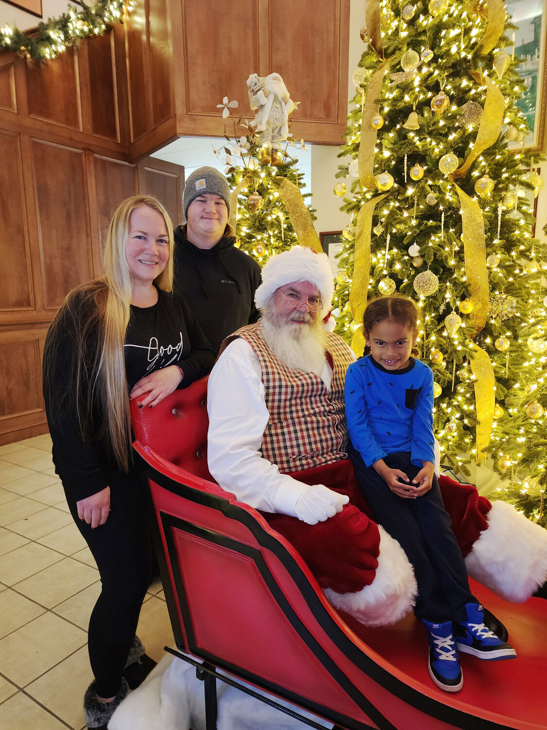 Ashley Myers with her kids, Curt Nagel and Kingston Smikle, enjoy family time with Santa.