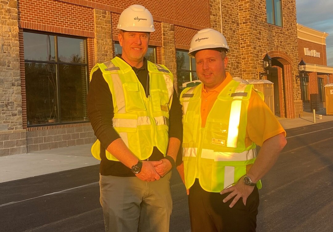Wegmans service area manager Dave Hemmer, left, stands with Bill Platt, store manager, in front of Wegmans’ second Bucks County store, which will open in the spring of 2024 in Lower Makefield.