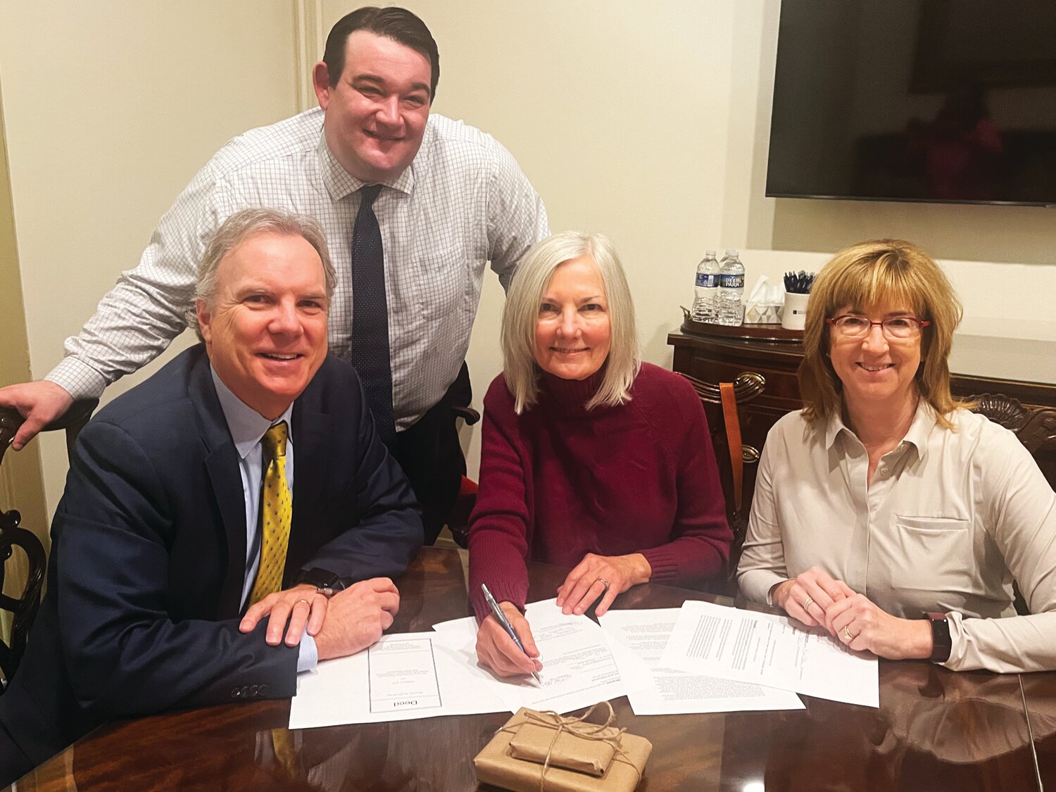 OHMTEC board President Greg Roth, left, Mike Peters, Highland Farm owner Christine Cole, OHMTEC board secretary-treasurer  Christine Junker at the closing for the purchase of the property.