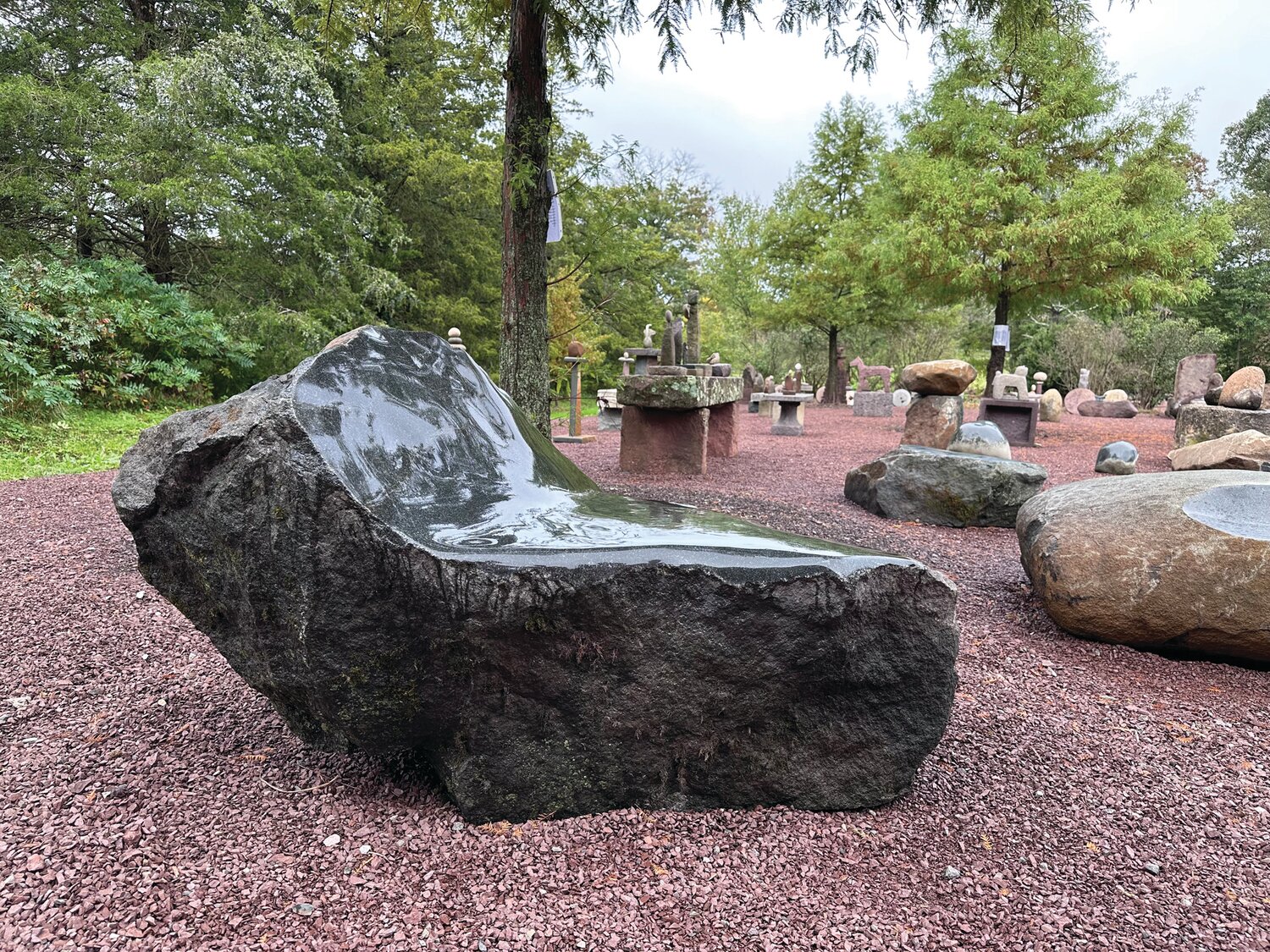 Justin Anchinsko “listens” to the stone before creating one-of-a-kind stone benches and stone sculpture.