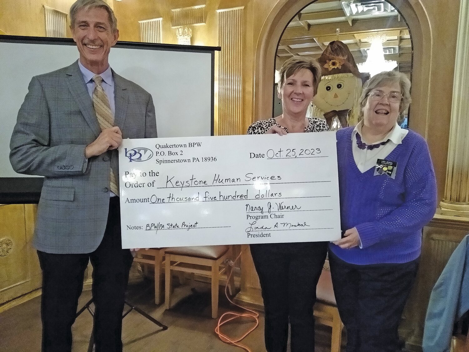 Dave Kunicki, director of intellectual disability services, is presented a check for $1,500 by Quakertown BPW Co-Presidents Jeanne Schlicher and Linda Moskal.