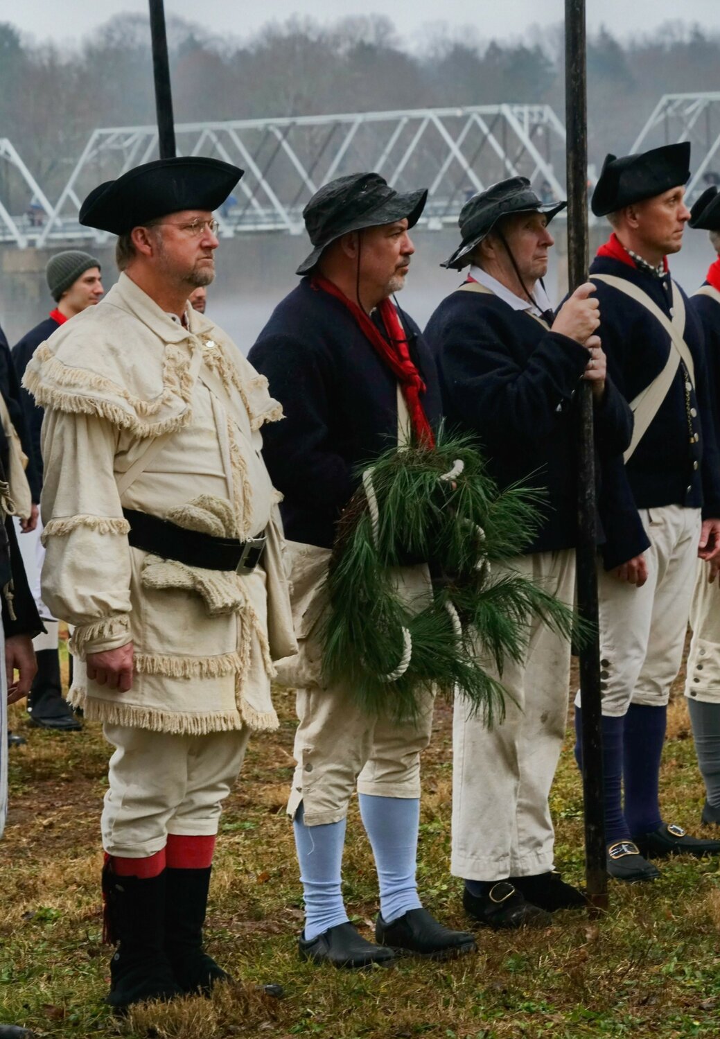 Reenactors stand at attention.