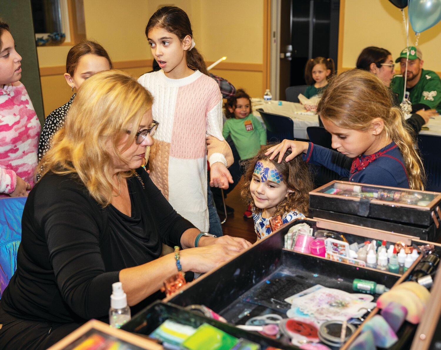 Children get their faces painted at the Family Chanukah Celebration.