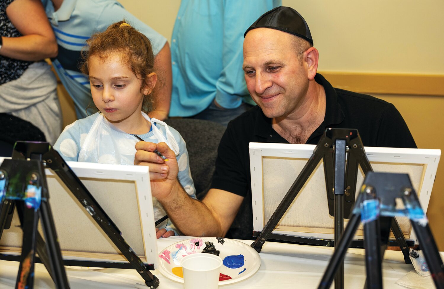Mila Raz and her father, Real Raz, take part in a painting activity.