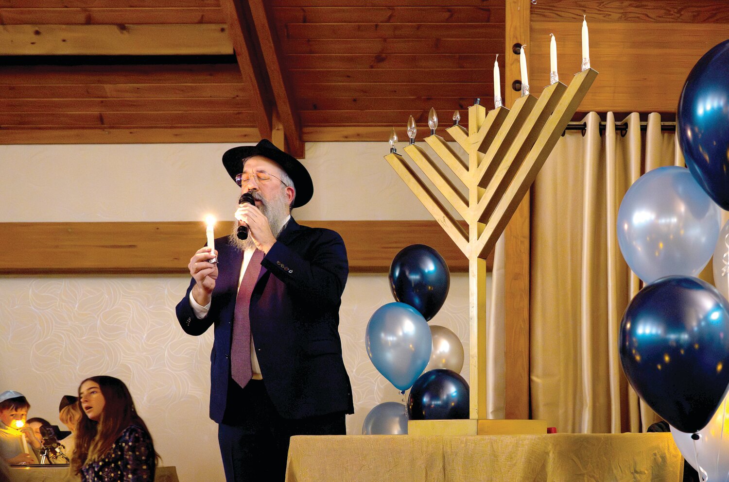 Rabbi Yehuda Shemtov speaks at the Family Chanukah Celebration.