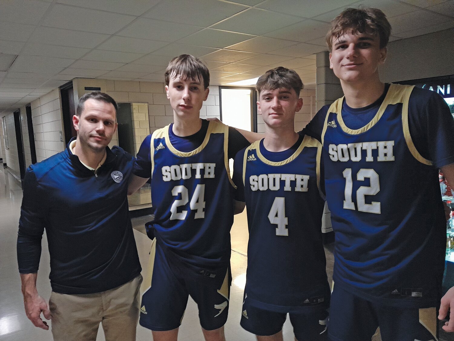 From left are: CR South boys basketball coach Andrew Rogers and players Ryan Wekluk, Mike Burns and Gabe Cerulli