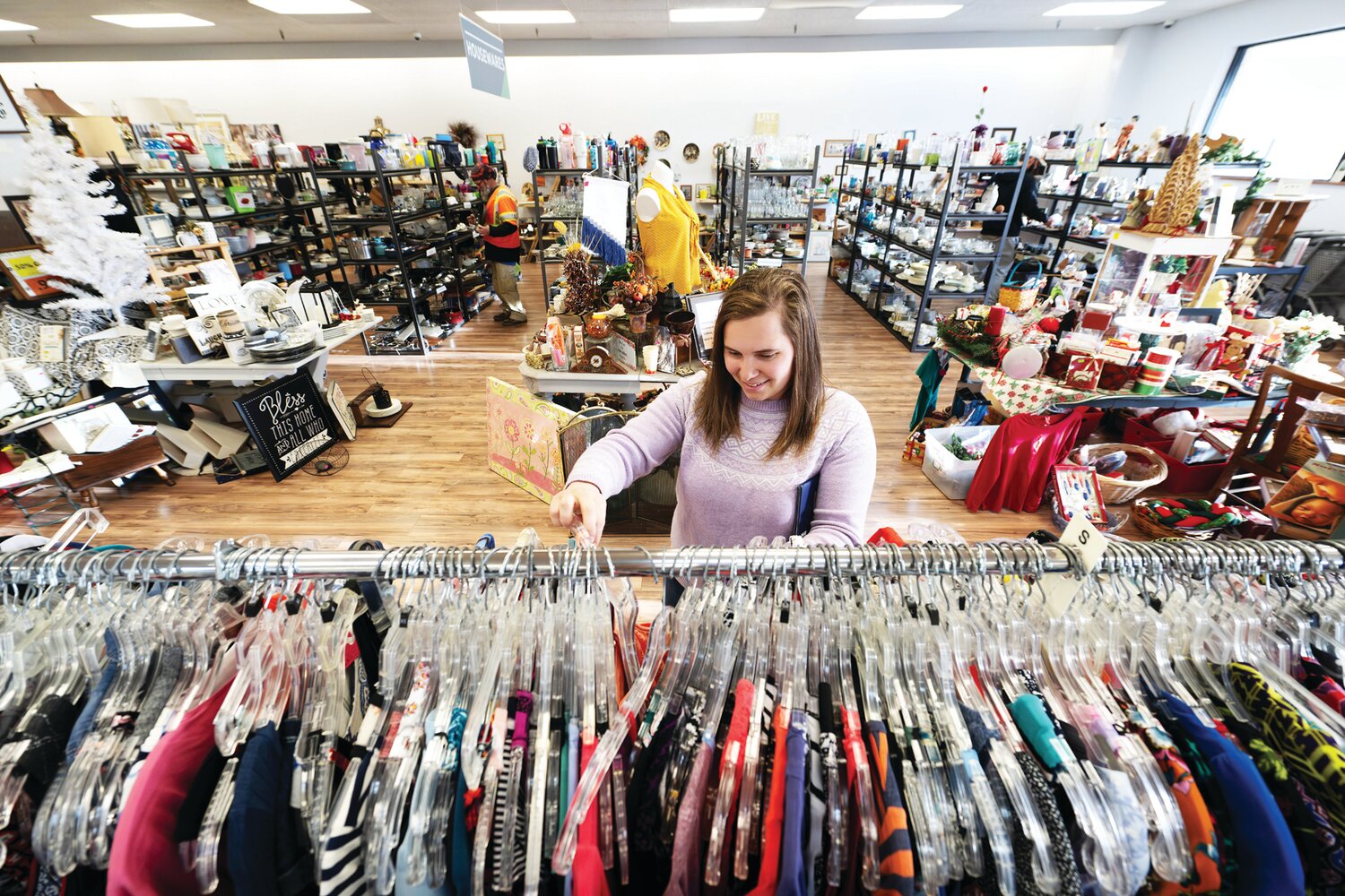 Shopper Abby Reiter looks through one of the clothing racks at Worthwhile Thrift in Plumstead Township.