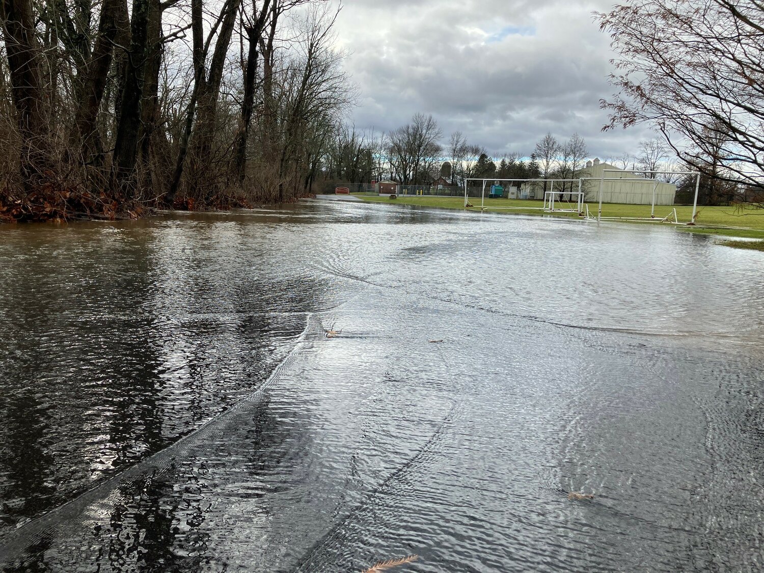 Lahaska Creek overflowed its banks Monday morning, flooded an access road to the Buckingham Elementary School property. The school was closed, Buckingham EMS officials said on Twitter, because of the resulting "access issues."