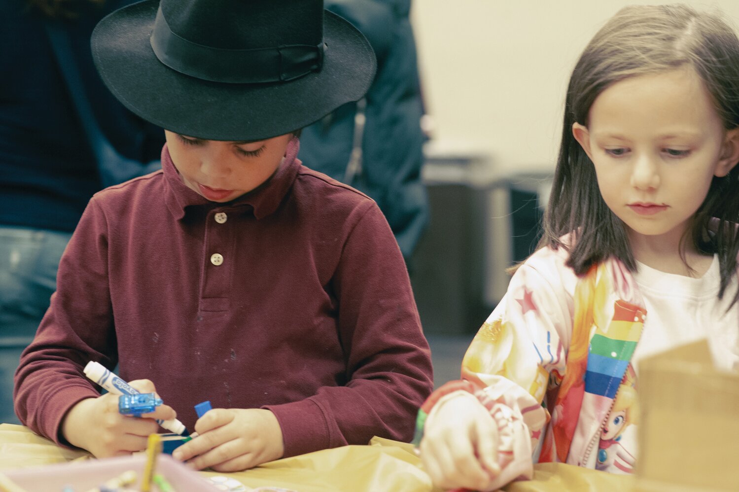 Yossi Trus, left, and Ava Berkowitz color their dreidels before starting to play the game at Chabad Lubavitch of Doylestown’s Light Up Doylestown – Public Menorah Lighting Dec. 12 at the Bucks County Justice Center.