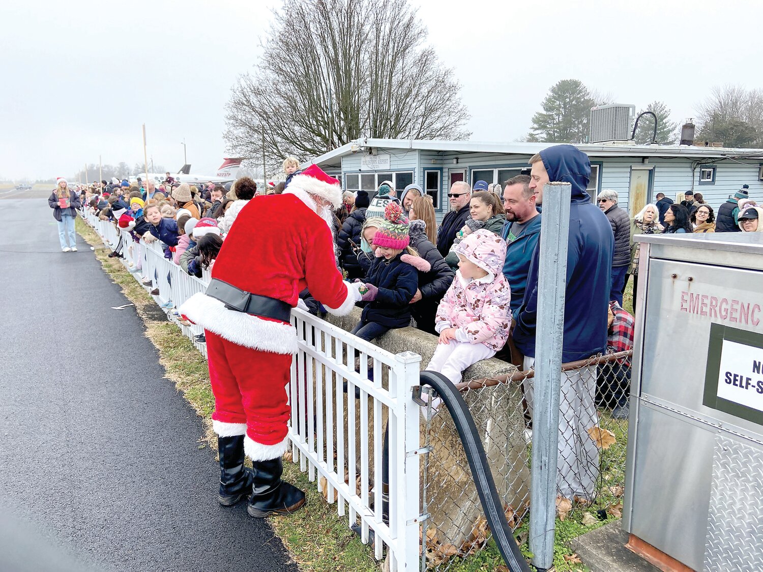 Families meet Santa Claus at Doylestown Airport. Santa handed out gifts to about 350 children at the airport on Dec. 9.