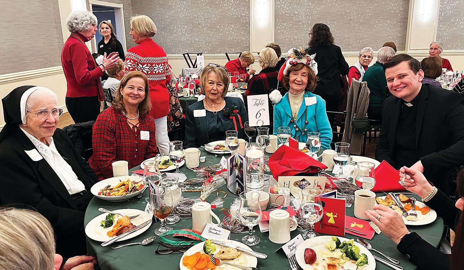 At the well-attended Ladies of Mount Carmel Christmas Luncheon Dec. 5 are, from left, Sister Thomas Ann; Dawn Parker, principal of OLMC School; Berni Padva, luncheon committee co-chair with Carol Chiappa (not pictured); Mary Ellen Stanton, committee member; and the Rev. Shane Flanagan.