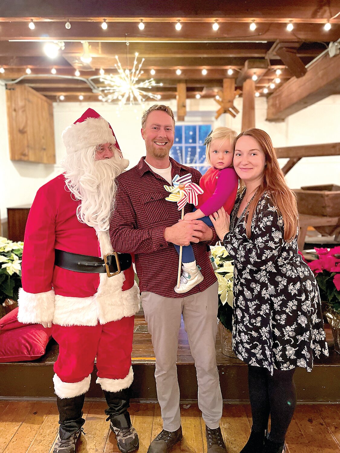 Curtis Klingler, Clara Phillips and Anna Klingler pose with Santa Claus at the Prallsville Mills Holiday Extravaganza for its members and the community on Dec. 10.