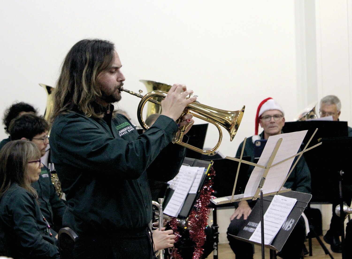Flugelhorn player Devon Mastrich of the Lambertville Brass Band performs a solo in the English rendition of “Away in a Manger” during a holiday party that the Veterans of Hunterdon County presented to the residents of Veterans Haven North.