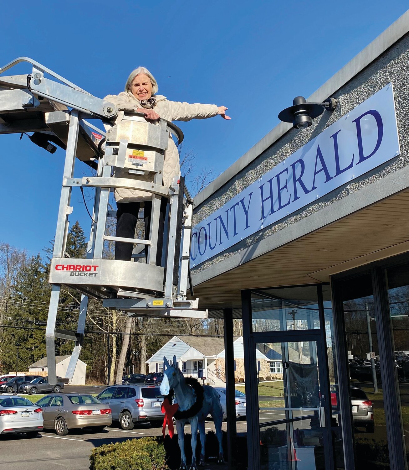Bucks County Herald founding editor Bridget Wingert got a lift last week so she could show off the sign that now adorns the Herald’s offices at the corner of North Easton and Saw Mill roads in Plumstead Township.