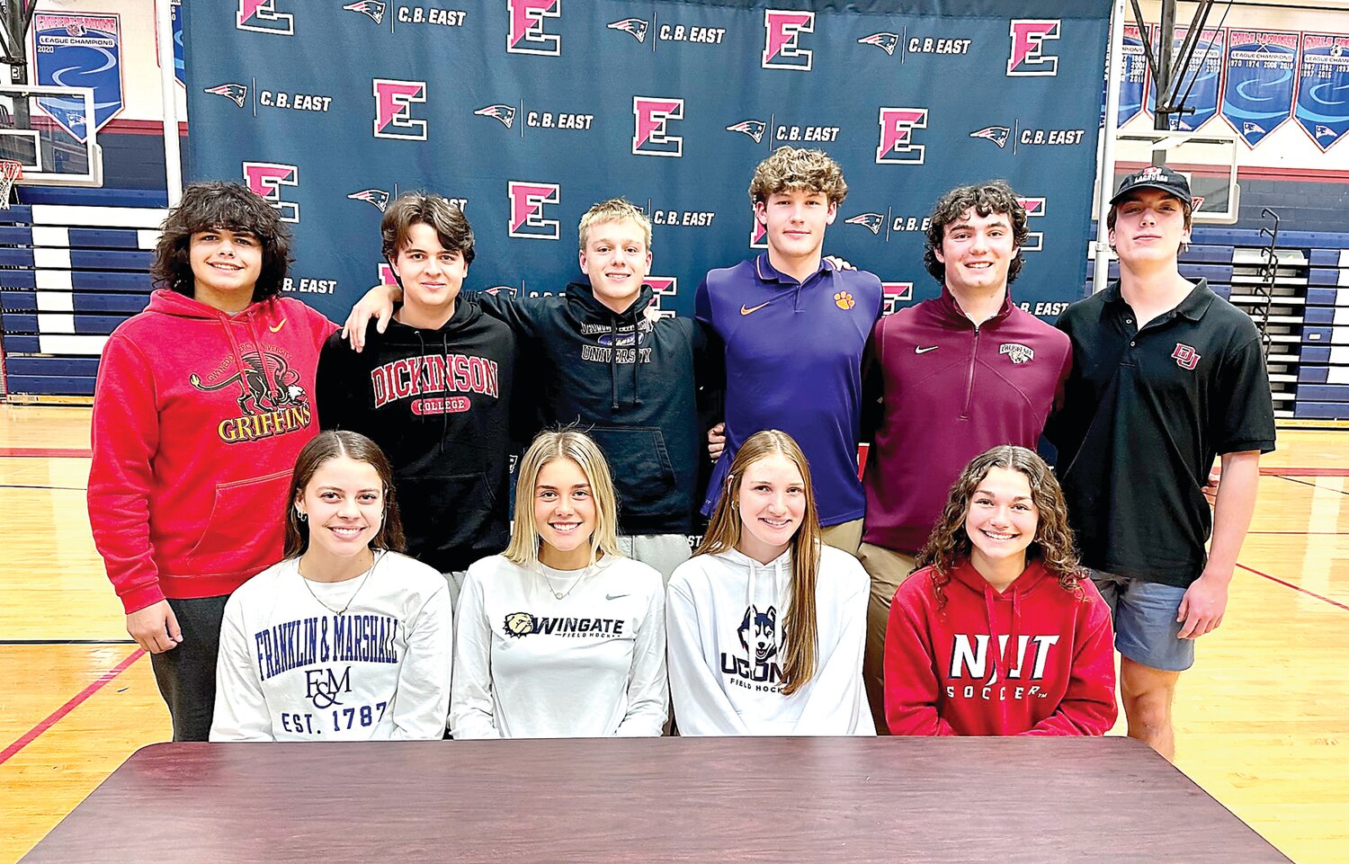 Ten Central Bucks East seniors were recognized on Nov. 13 for their commitment to compete in collegiate sports. From left are: front row, Grace Craig, Audra Szymborski, Paige Keller, Sofia Mignon; back row, David Crespo, Sam Bliss, Reece Moody, Chase Harlan, Jack Mislan and Patrick Coleman.