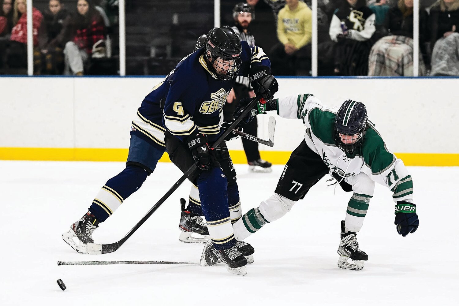 Pennridge’s Andrew Savona loses his stick while battling Council Rock South’s Kevin Koles for a loose puck in the third period.