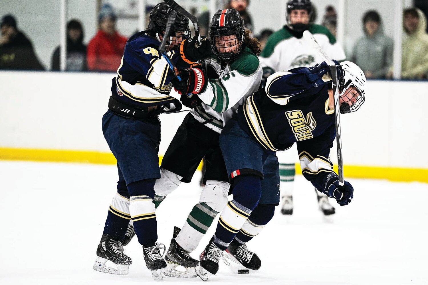 Pennridge’s James Rush tries to split the squeeze from Council Rock South’s Jake Weiner and James DiIulio in the third period.