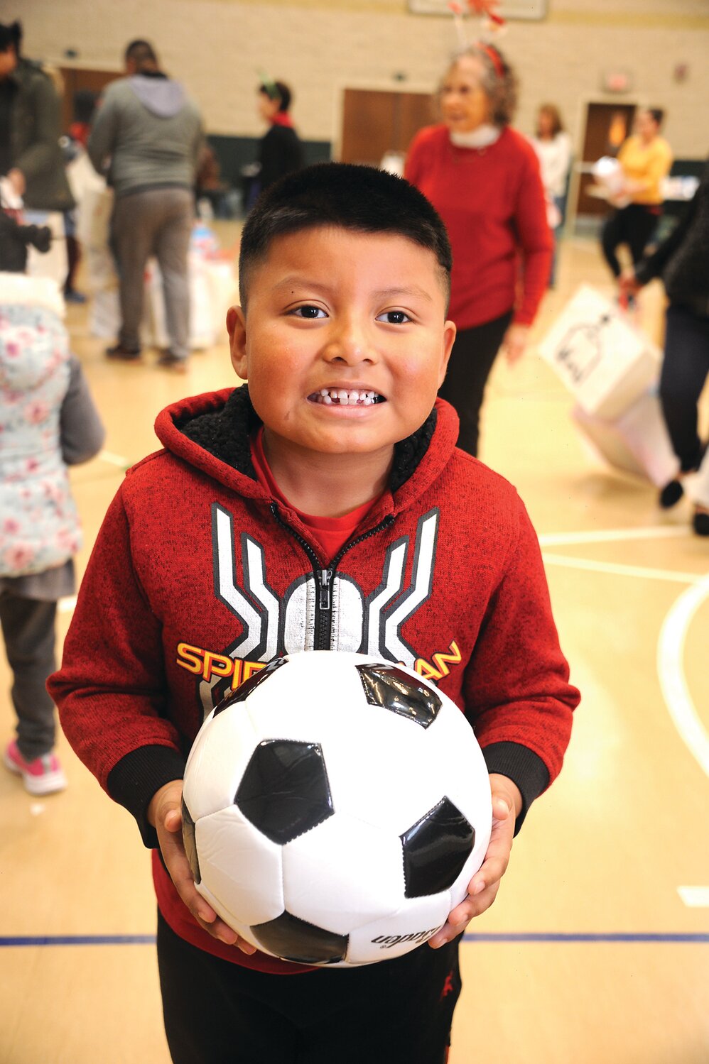 Brandon holds a soccer ball.