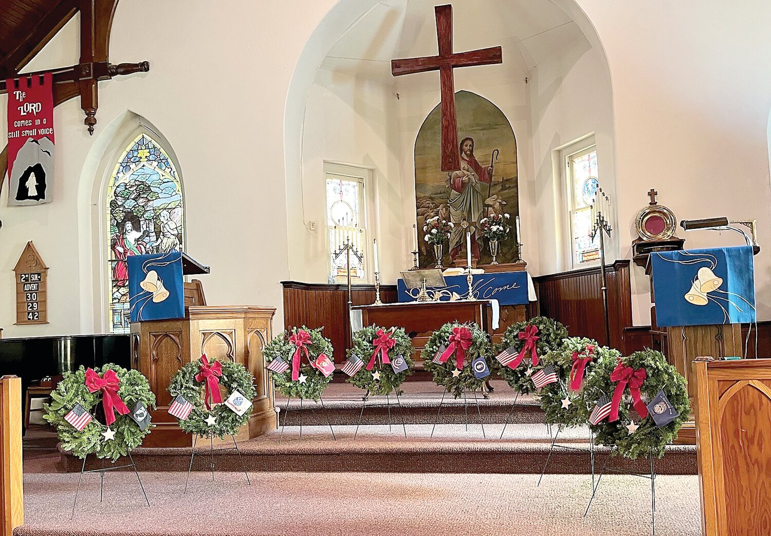 Special extra-large wreaths donated by Wreaths Across America line the altar steps at the Upper Tinicum Lutheran Church in Upper Black Eddy.