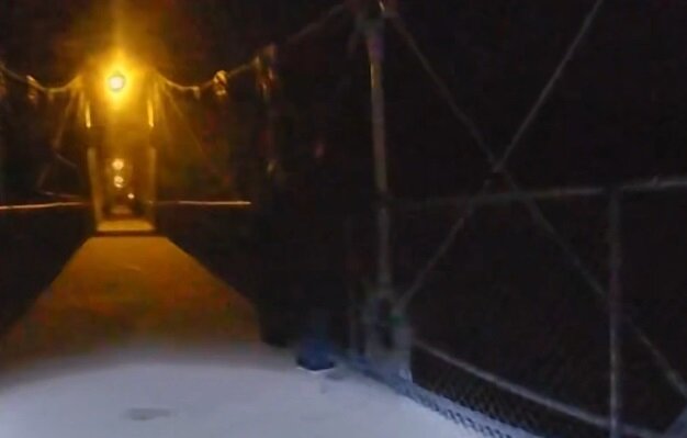 A still from the body camera worn by one of the officers who responded to the Lumberville Foot Bridge early Monday morning shows two officers standing at the railing near the spot where a woman reportedly climbed over the railing and threatened to jump.