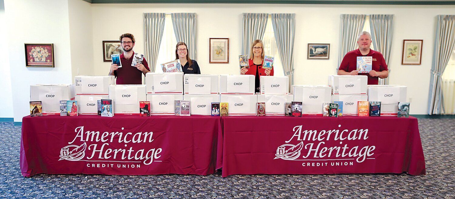 American Heritage associates present Children’s Hospital of Philadelphia’s Reach Out and Read Program with a donation of 2,650 books to promote early literacy and school readiness in pediatrics. From left are Brand Commo, American Heritage Credit Union; Gina Pelbano, American Heritage Credit Union; Kirsten Rogers, coordinator, Reach Out and Read at CHOP; and William Quinn, American Heritage Credit Union.