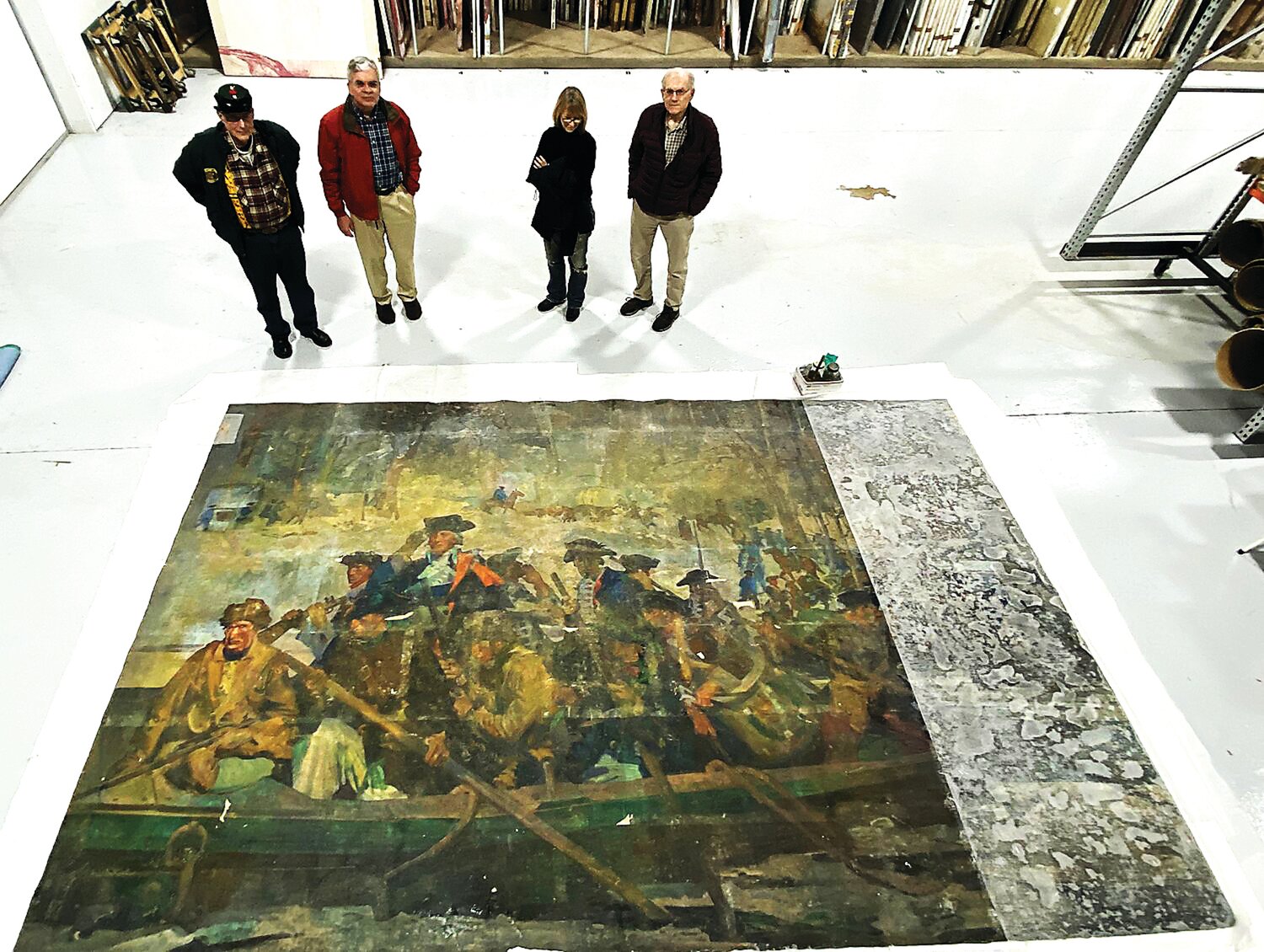 Conservator Christyl Cusworth, second from right, and Washington Crossing Park Association trustees, gather around a 15-foot, 6-inch by 9-foot, 8-inch mural by American muralist George Matthews Harding, which was unearthed and is being restored by the volunteer friends group of Washington Crossing State Park.