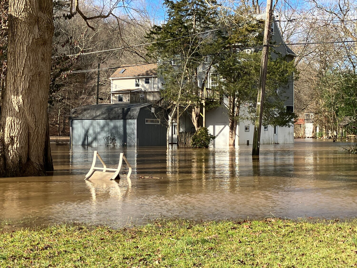 Rain overflows the banks of the Neshaminy Creek onto properties on Mistletoe Drive in Middletown Township.