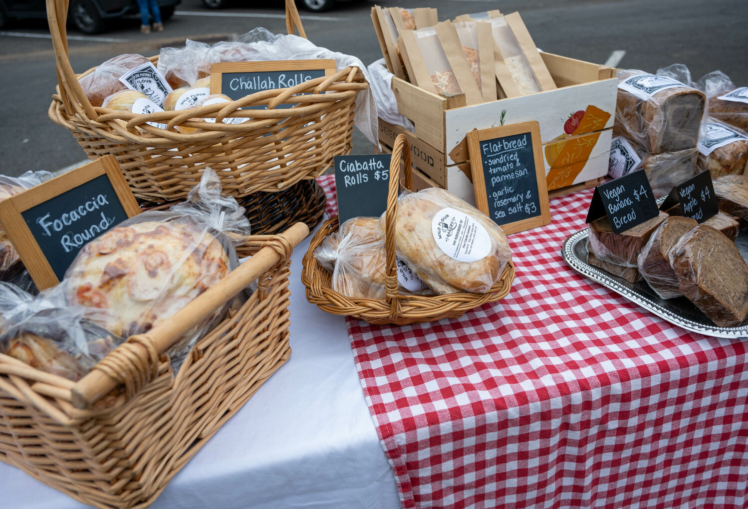 Wild Flour Bakery sells an assortment of bread products to farmers market customers.