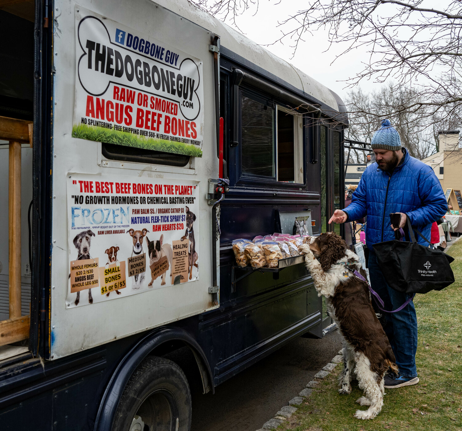Sam Bever and his dog, Echo, check out the inventory at The Dog Bone Guy’s truck.