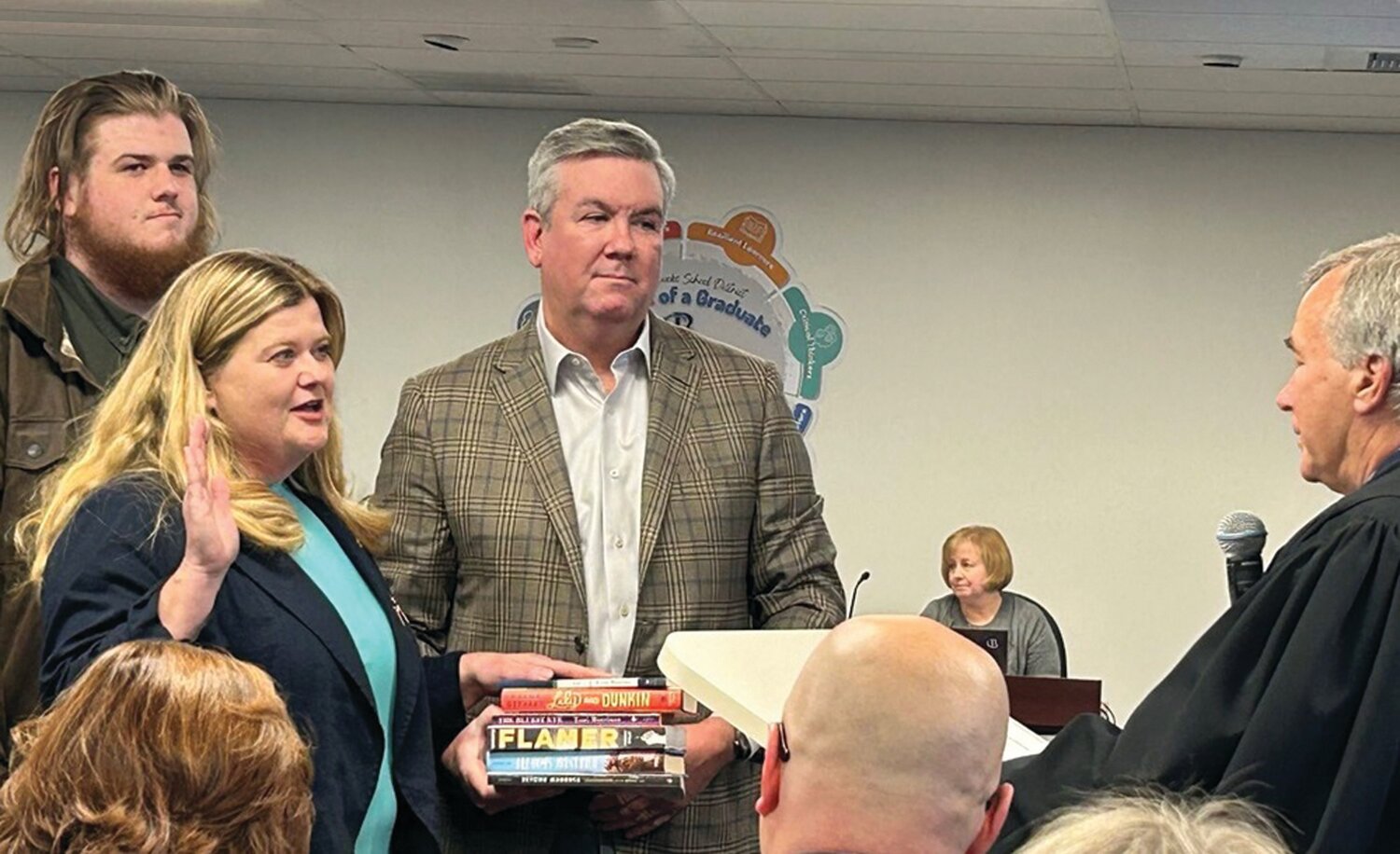 Karen Smith placed her hand on six books, five of which the previous school board had challenged as “inappropriate,” as she was sworn in to her seat on the Central Bucks School Board. Smith’s husband, Peter, held the books, as Smith’s son, Alex Smith, looked on. None of the books was removed. The sixth book had been challenged in another school district.