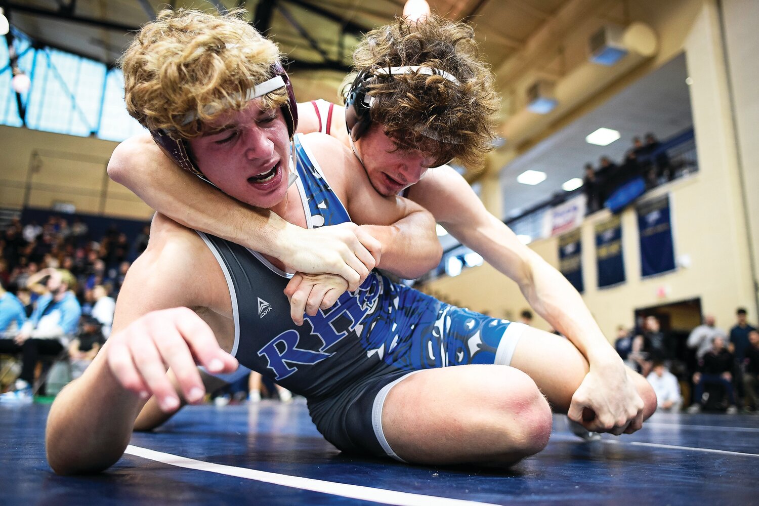 Faith Christian’s Max Stein has the upper hand on Riverbend’s Carson Main in the 152-pound weight class.