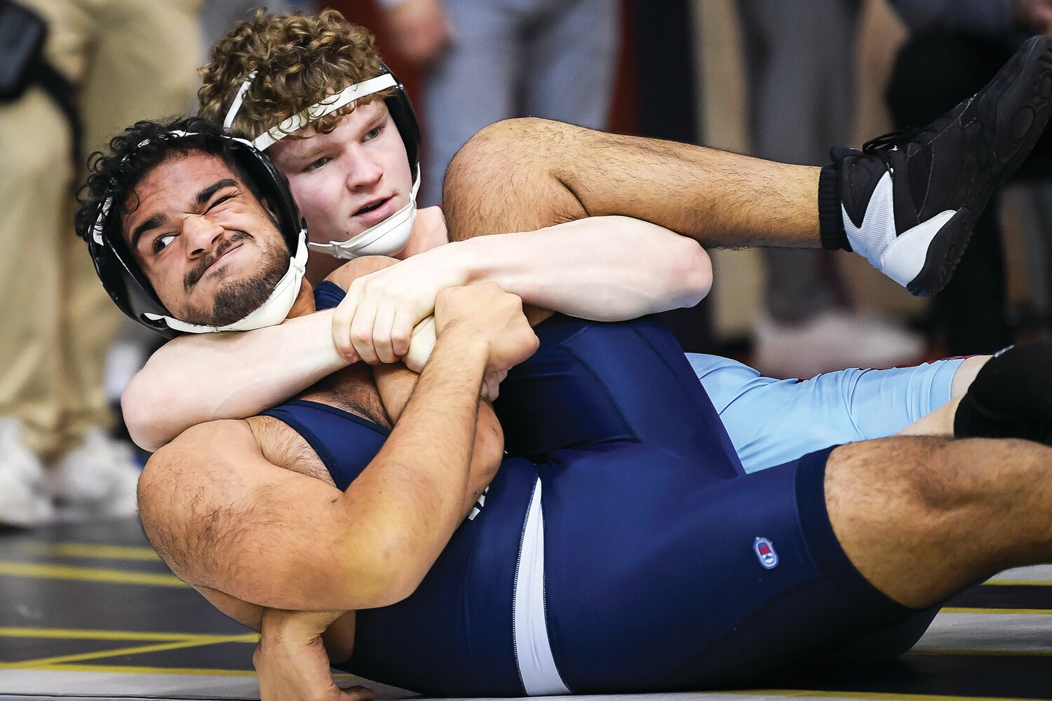Council Rock North’s Arya Chaudhary feels the grip of Faith Christian’s Cael Wiedemoyer while losing a 160-pound match.