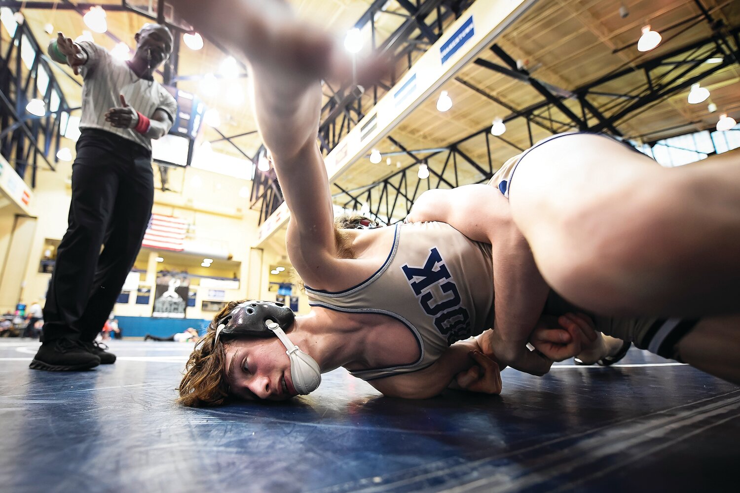 Council Rocks South’s Eddie Alvarez gets planted after a fall by State College’s Noah Young during his 107-pound match.