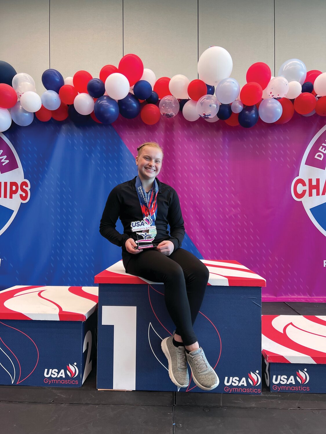 Gymnast Ruthie Wehrung poses with her hardware.