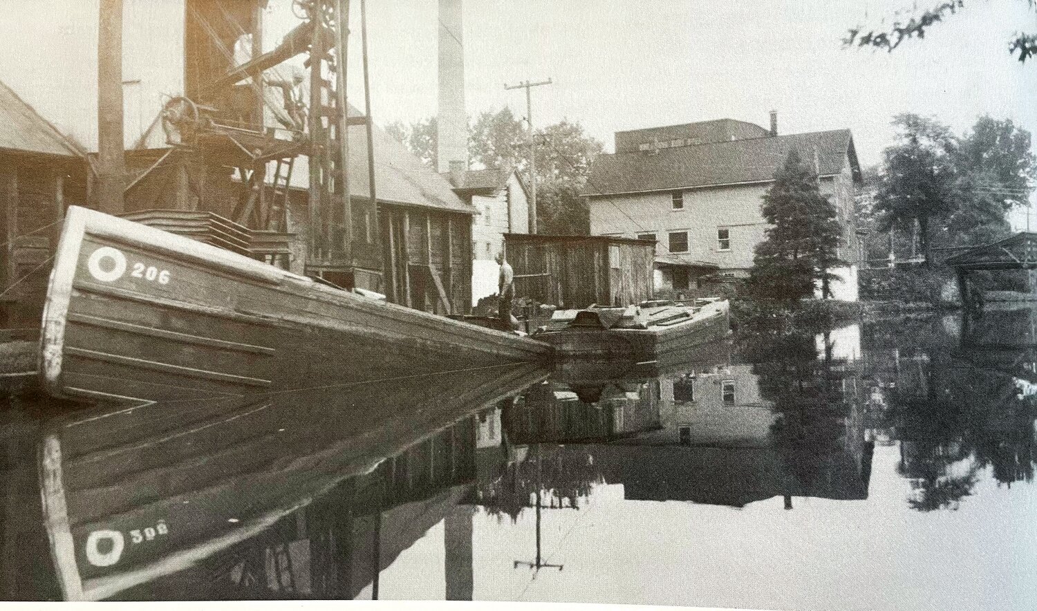 A hinge boat, the most common type of boat used on the Delaware Canal, is off-loaded at the Leedom Coal Yard.