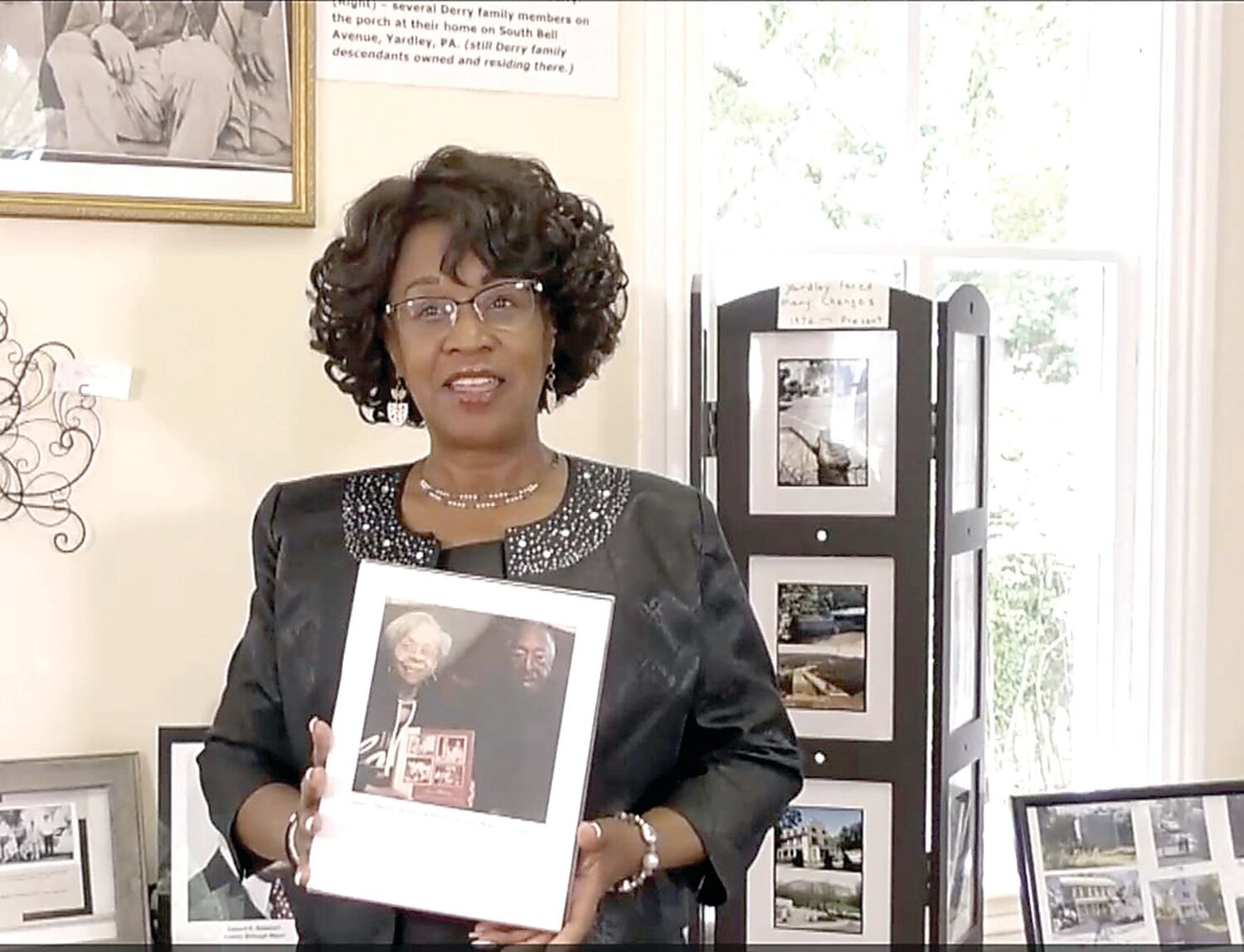 Shirley Lee Corsey, executive director of Gather Place Museum, holds a photo from Generational Voices Project.