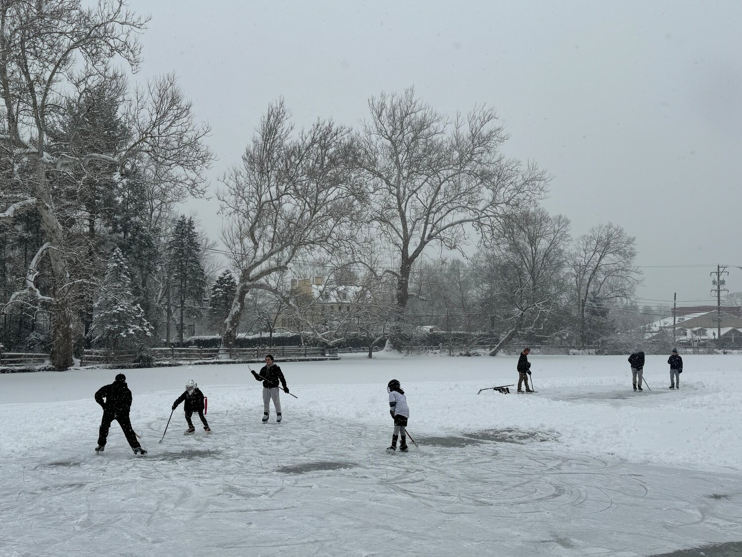 Frozen-over Lake Afton, in Yardley, became a makeshift ice hockey rink Friday as local children laced up their skates and enjoyed an unexpected day off from school.