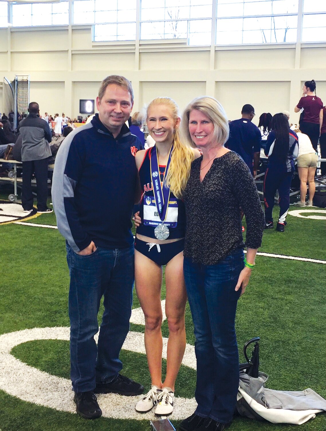 At the 2017 Southeastern Conference championships, Auburn University’s Veronica Eder, center, is congratulated by her dad, Jim left, and mom, Karen, after Veronica finished second in the 5,000 meters and third in the 3,000 meters.