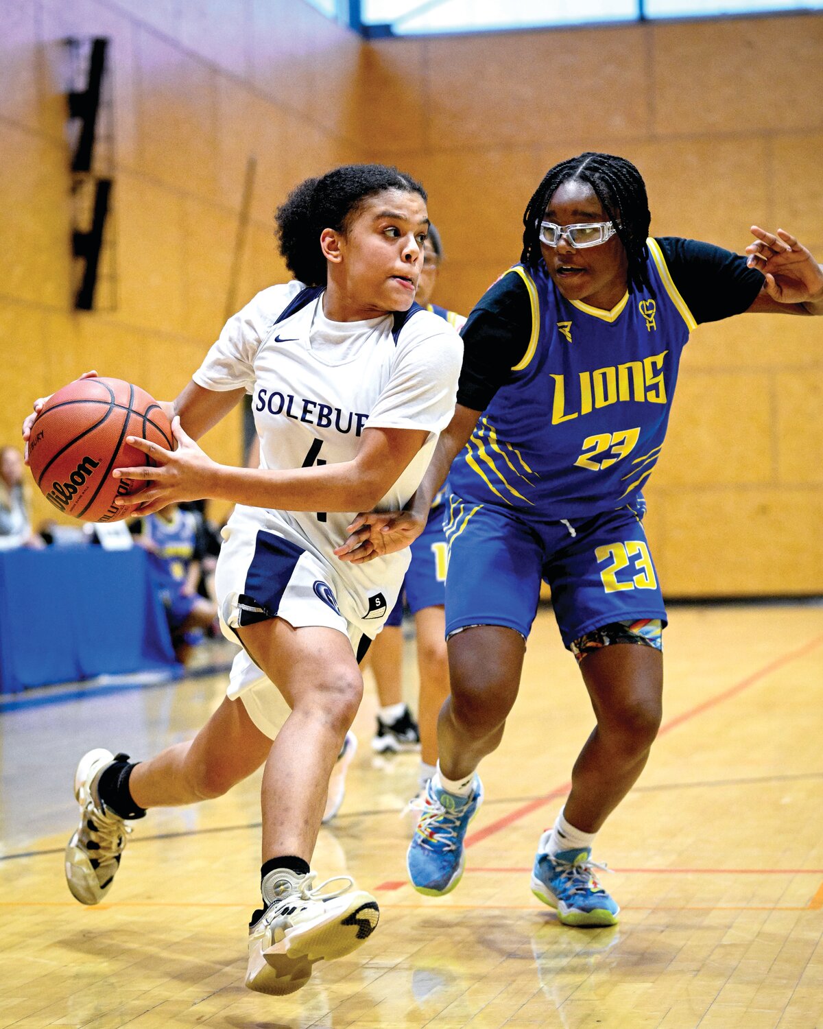 Solebury School’s Tyler Joseph races around the baseline and the defense of The City School’s Janiah Green for a shot attempt in Saturday’s White Out girls basketball game.