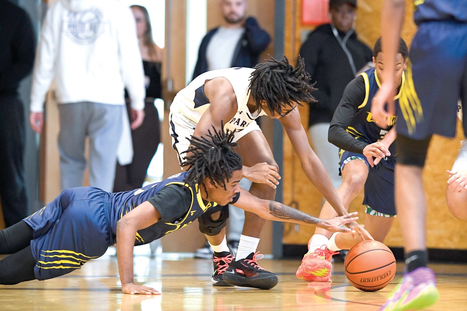 City’s Talan Hawkins lunges for a loose ball in front of Solebury’s Ari Johnson.