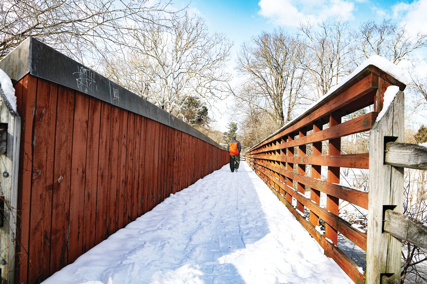 A man crosses a snow-covered bridge over the Delaware Canal in Point Pleasant.