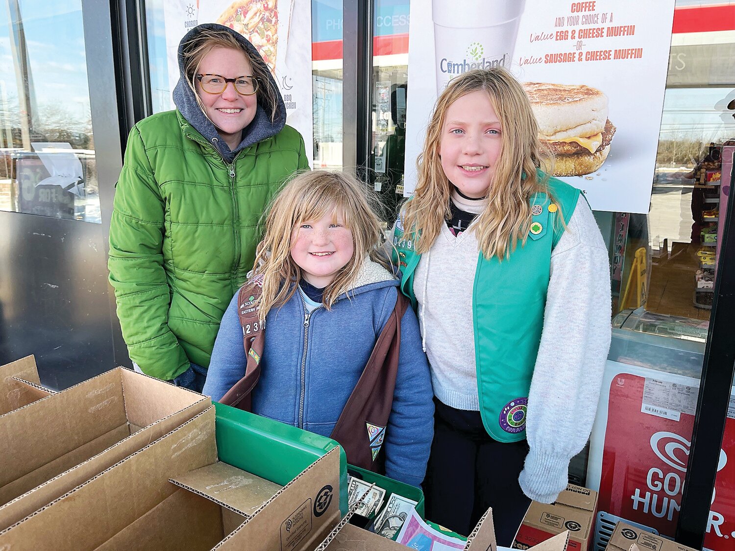 Selling cookies outside Turkey Hill on a frigid Saturday afternoon are (from left) Danielle Watson, Tinicum Girl Scout Troop 02390 leader, and her daughters, Girl Scouts Ivy Watson, 8, and Isabelle, 11.