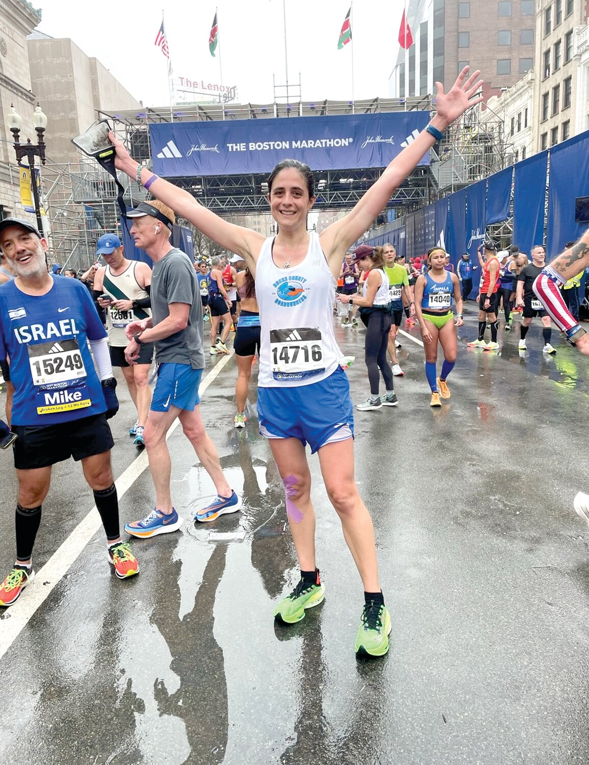 At the 2023 Boston Marathon, Morgan Leh celebrates her finish.